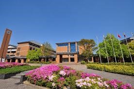 Kansai Gaidai Campus, with a flowerbed and buildings in the back